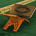 A small wooden stand with a book on top of it