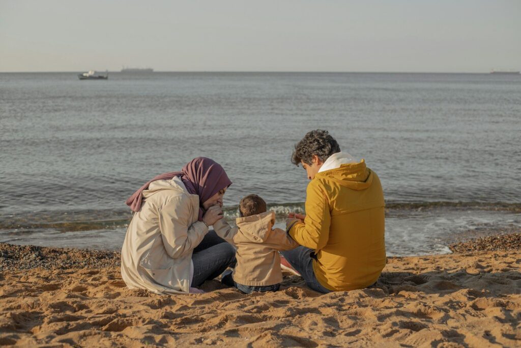 a group of people sitting on a beach