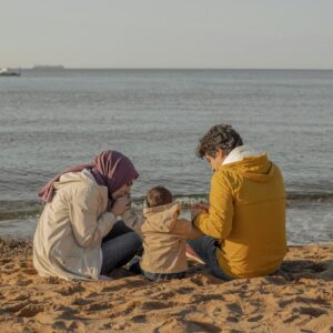 a group of people sitting on a beach